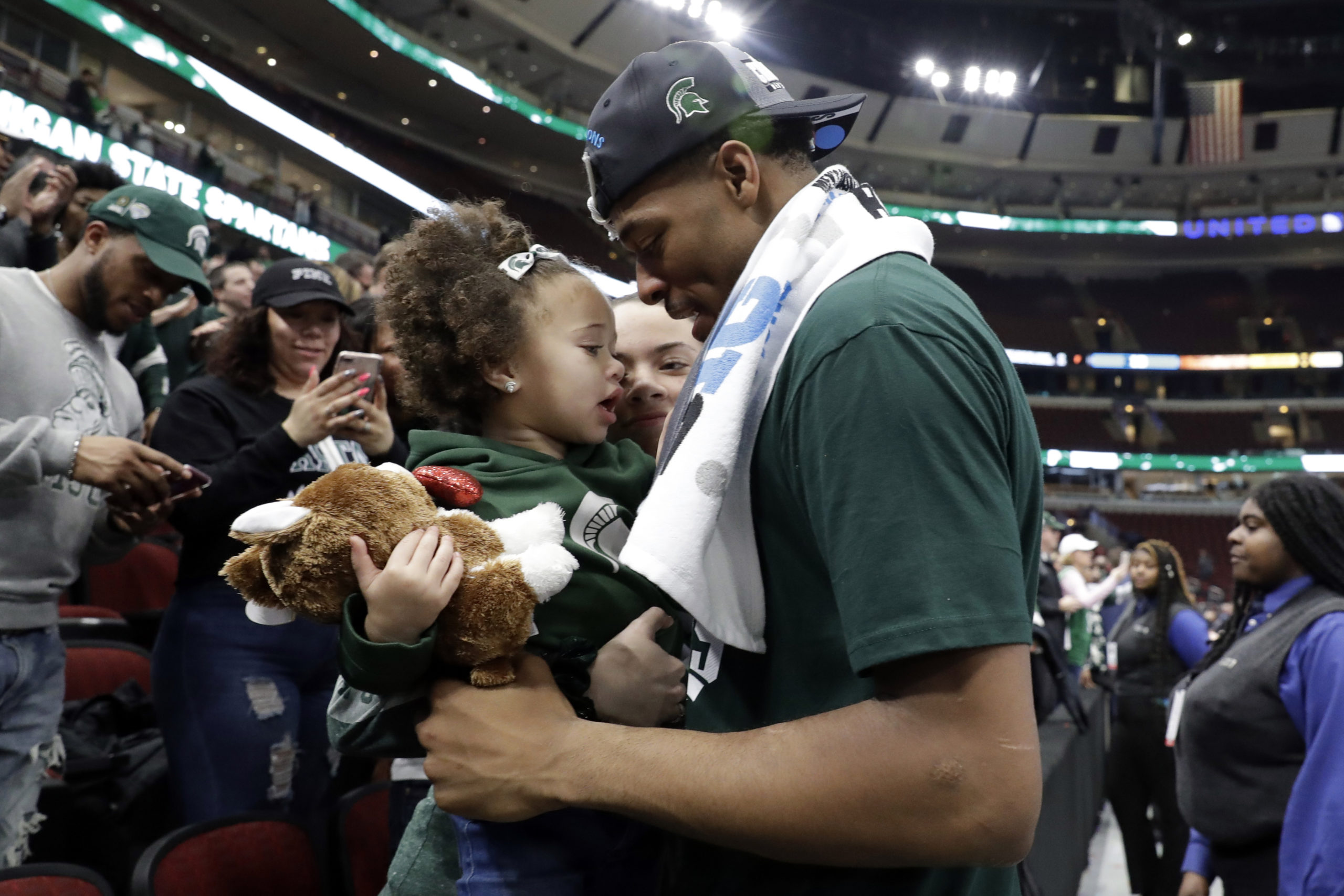 Michigan State's Xavier Tillman celebrates with his daughter after defeating Michigan 65-60 in an NCAA college basketball championship game in the Big Ten Conference tournament, Sunday, March 17, 2019, in Chicago. 